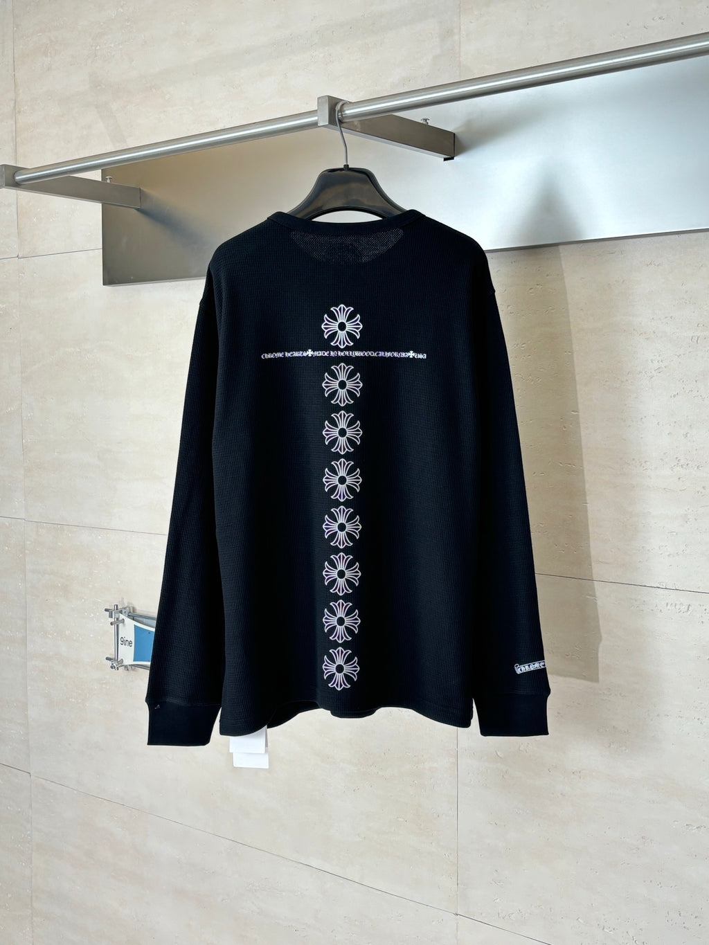 Black long-sleeve crewneck shirt with white vertical back graphic