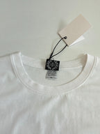 White long-sleeve T-shirt neckline with brand label and size tag.