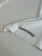 White T-shirt sleeve with black outlined logo text.