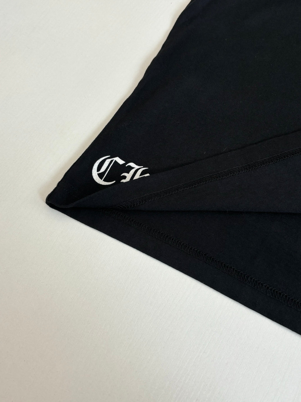 Black long-sleeve cuff with small embroidered logo detail