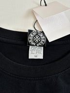 Black crewneck top neckline with size tag and logo patch