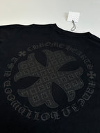 Black long-sleeve top with large cross-style back graphic