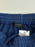 Blue elastic-waist shorts with Balenciaga label and attached white hang tag