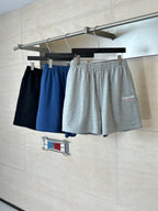 Assorted shorts on hangers: navy, blue, and gray heather with elastic waist and drawstring