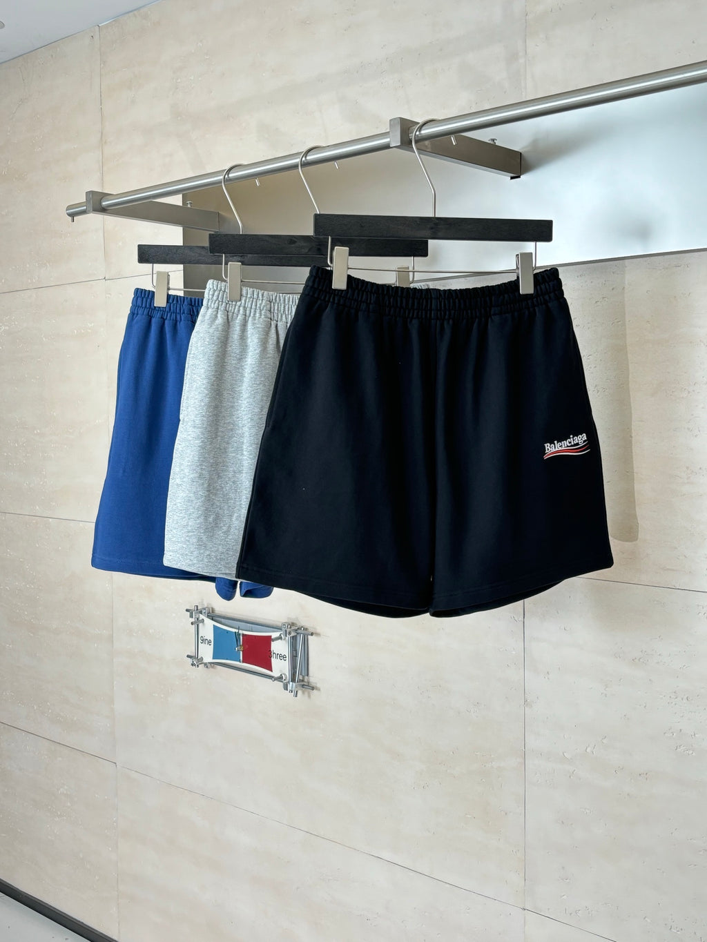 Set of drawstring shorts in black and blue-gray tones on hangers