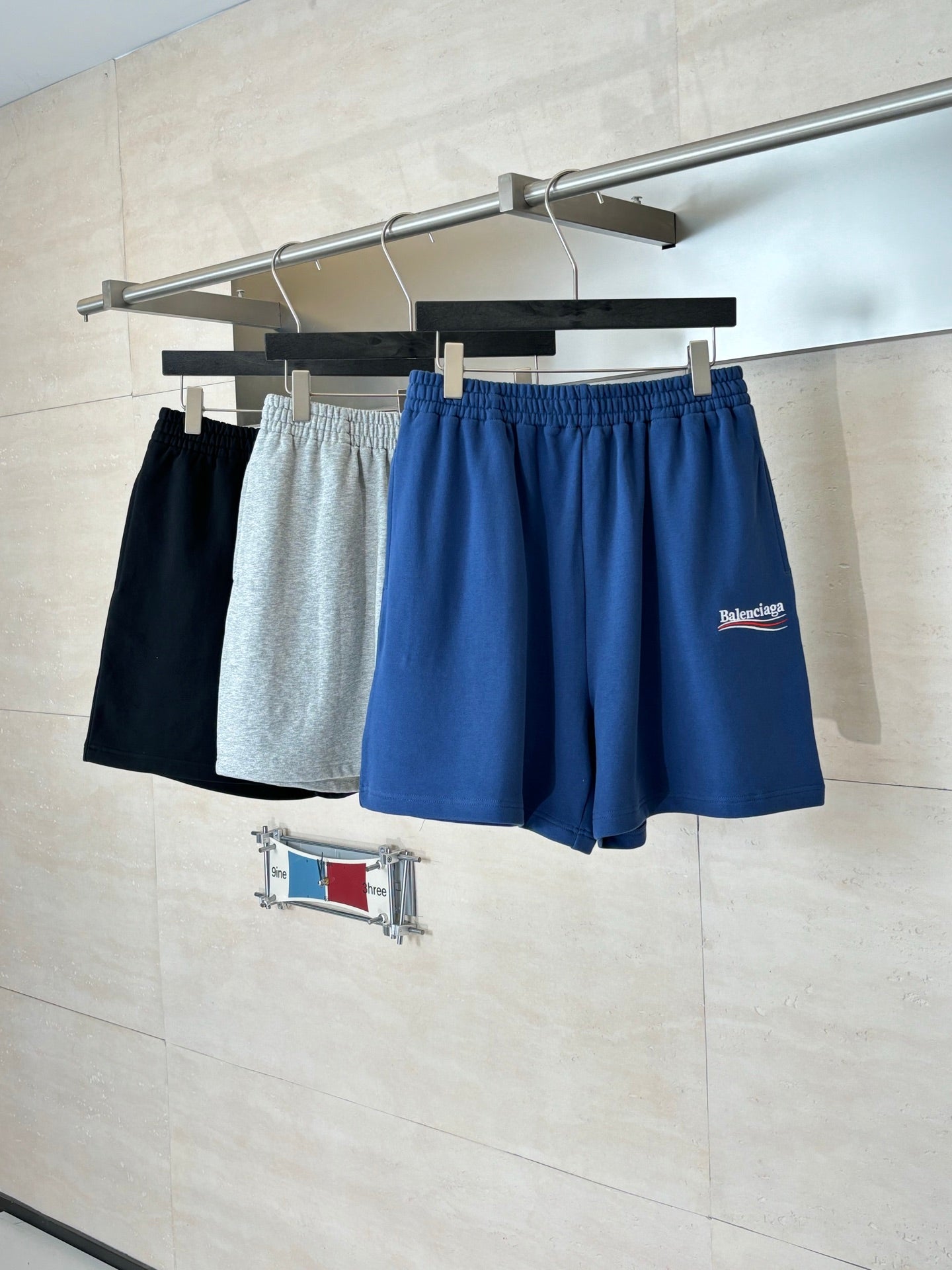 Balenciaga shorts set: blue and gray drawstring shorts on hangers