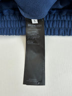 Blue shorts size and brand label on waistband area, care information tag shown