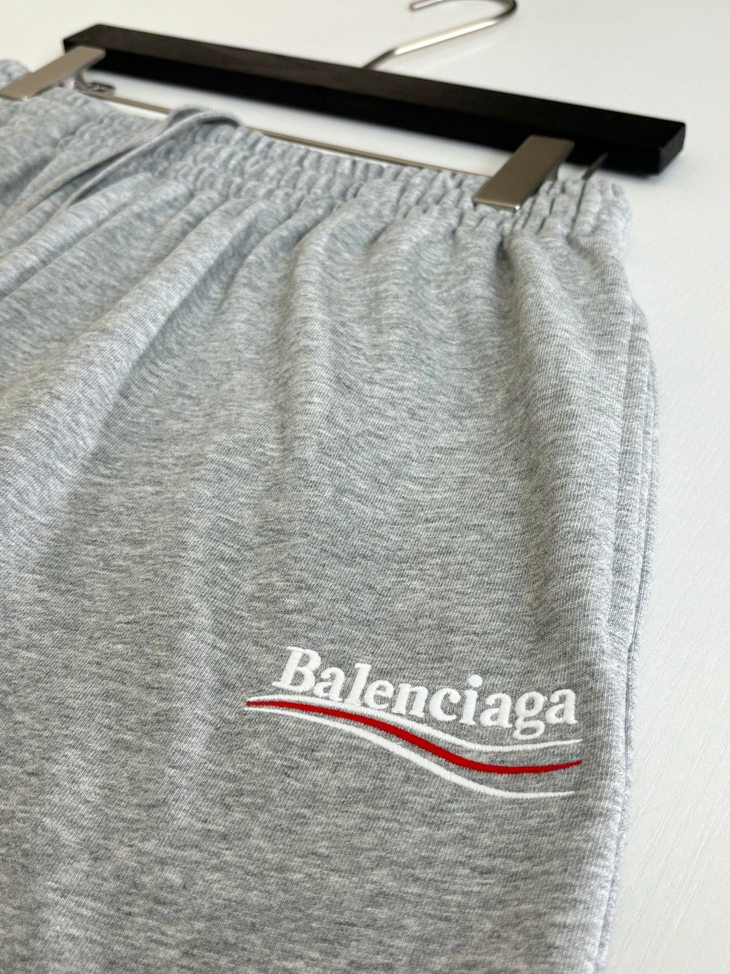 Balenciaga heather gray shorts with embroidered “Balenciaga” logo and red/blue underline