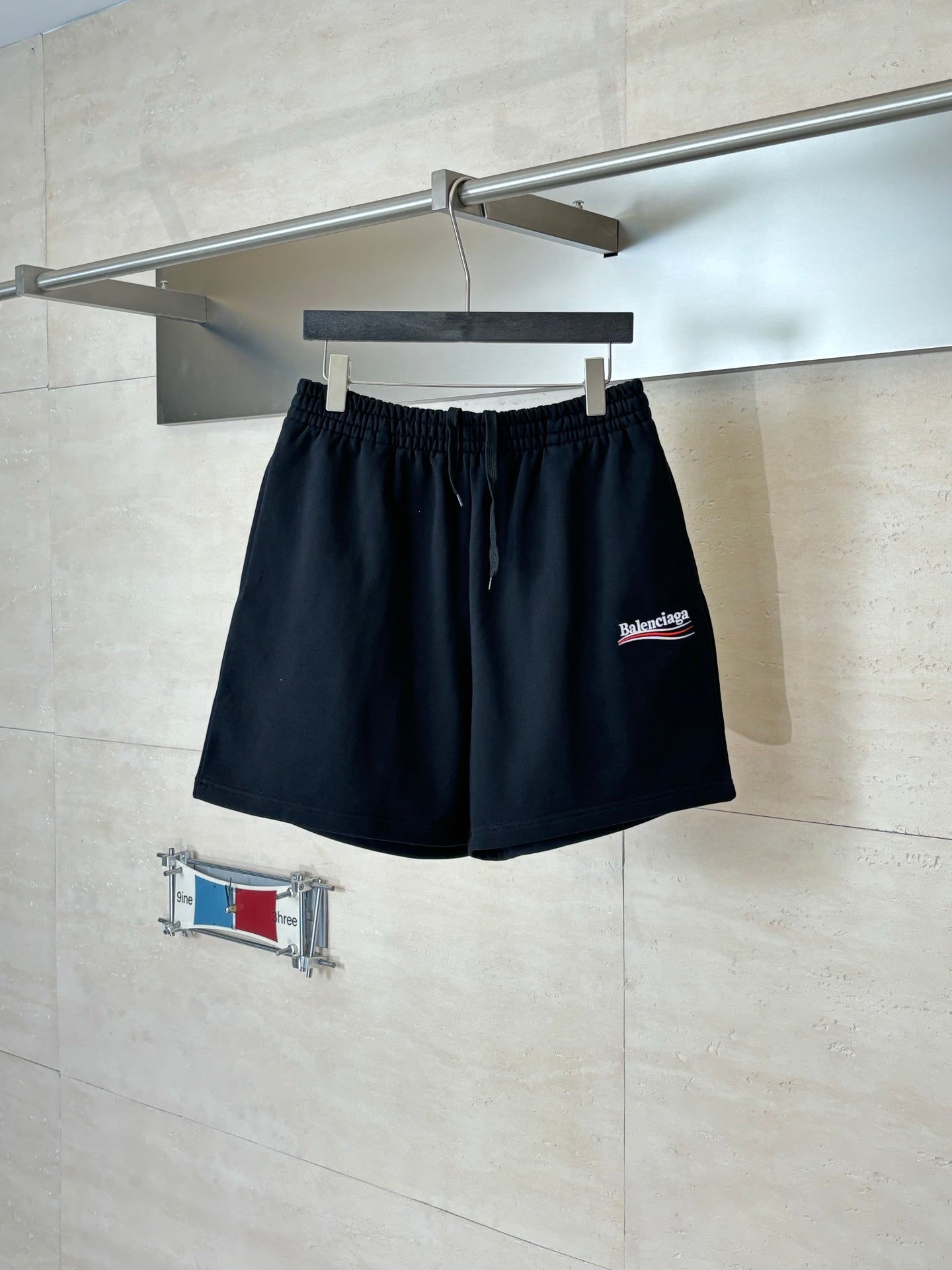 Black drawstring shorts with elastic waistband and Balenciaga logo patch