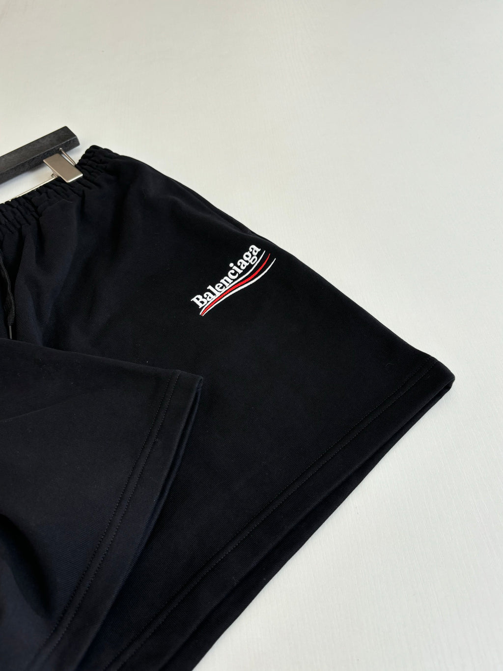 Black drawstring shorts close-up with Balenciaga logo on side