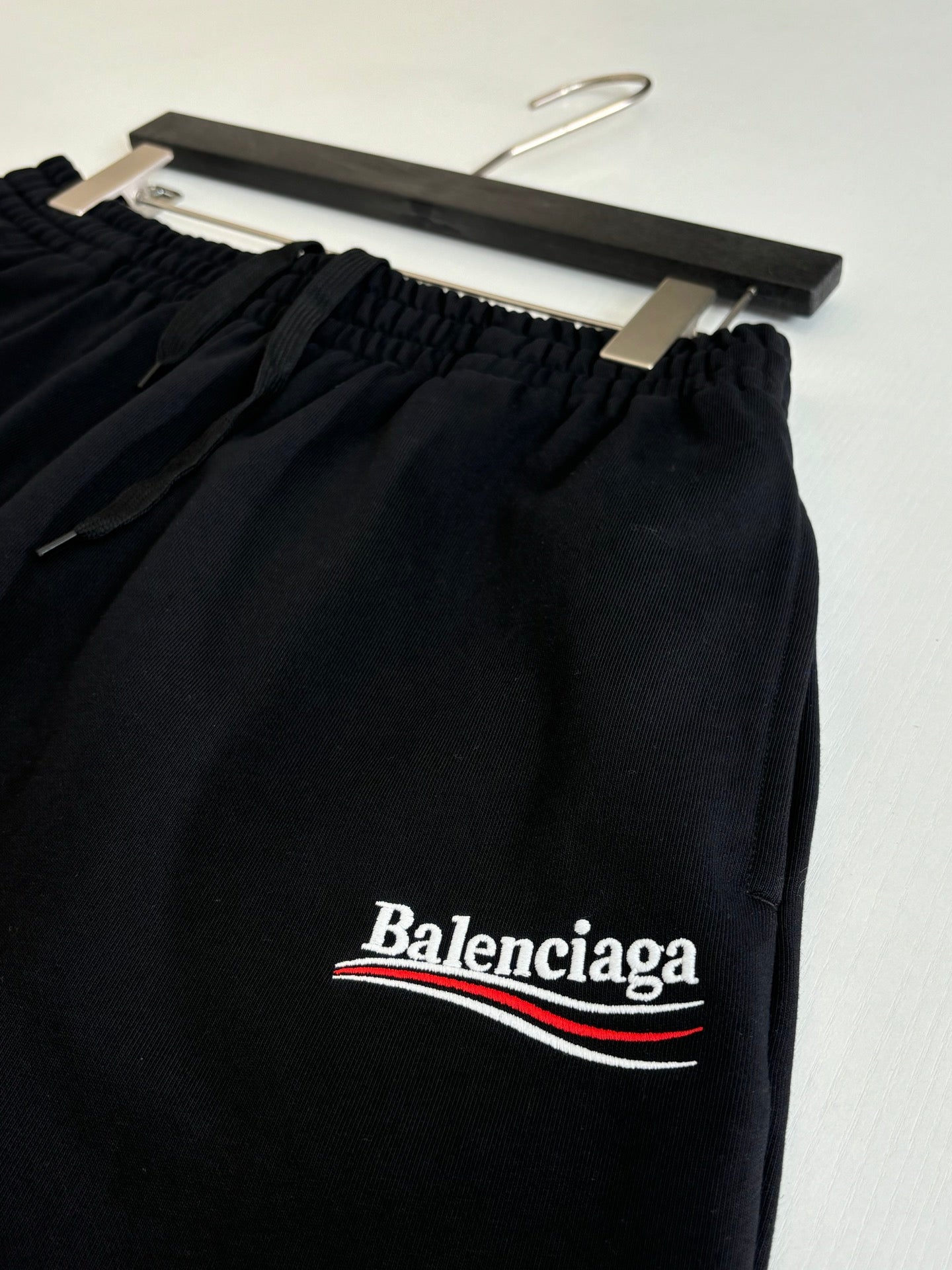 Black drawstring shorts with Balenciaga logo print on front