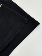Black shorts fabric with side seam stitching and angled hem view