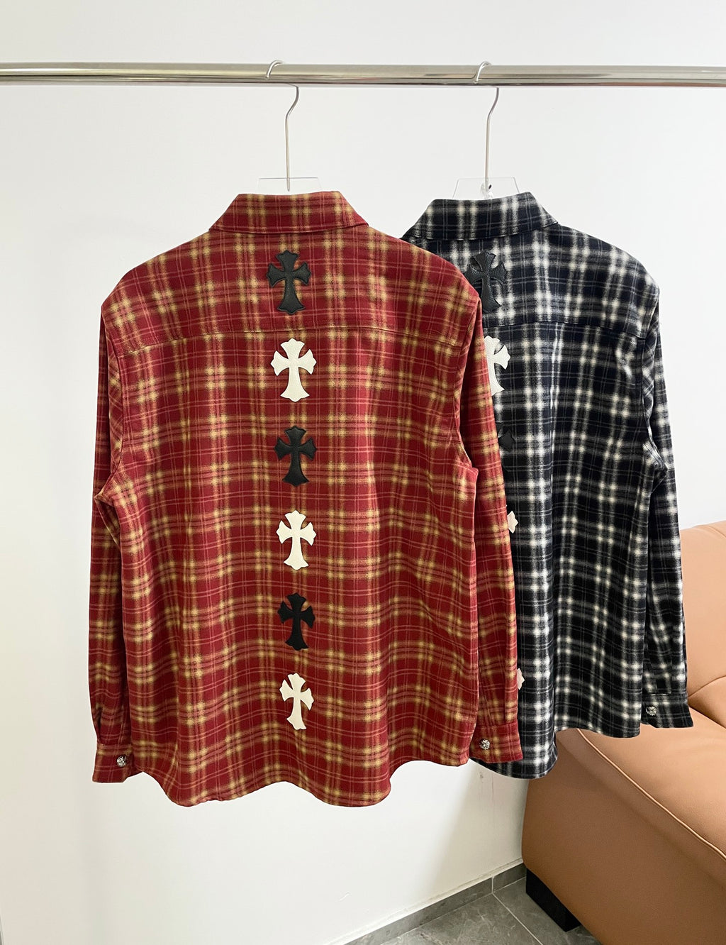 Back view of long-sleeve red plaid button-up shirt with white cross appliques