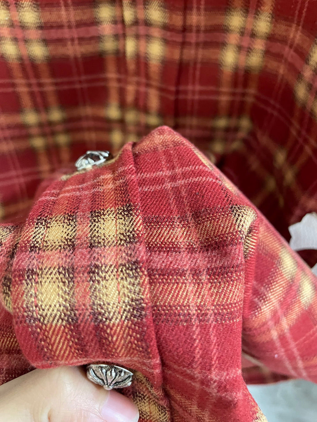 Red plaid shirt back with yoke stitching and small metal button