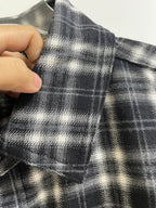 Black and white plaid fabric swatch with textured woven grid