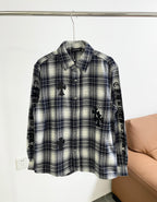 Blue and white plaid long-sleeve button-up shirt with black embroidered motifs