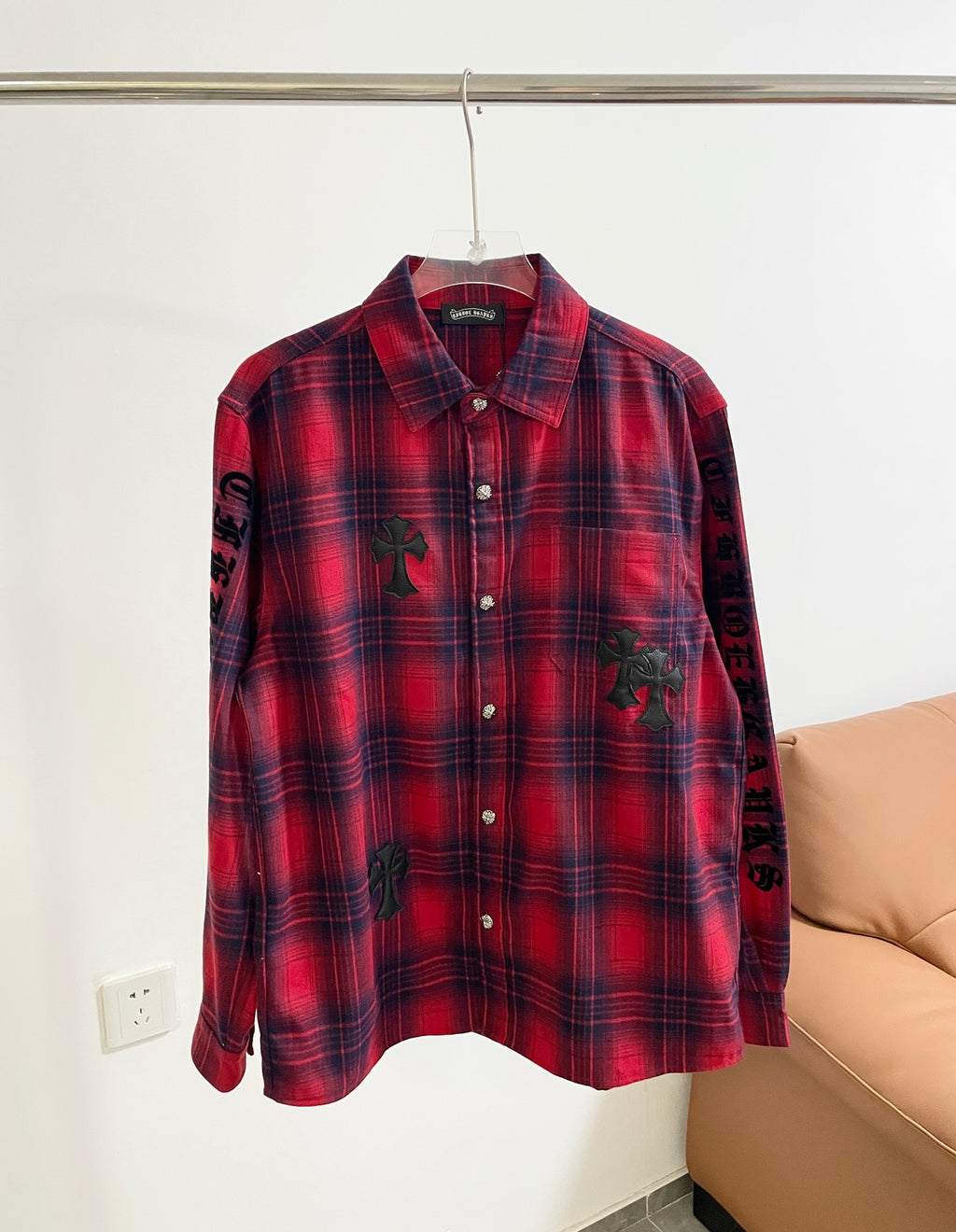 Red plaid long-sleeve button-up shirt with black embroidered motifs