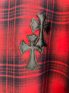 Red plaid shirt with dark embroidered cross emblem on front