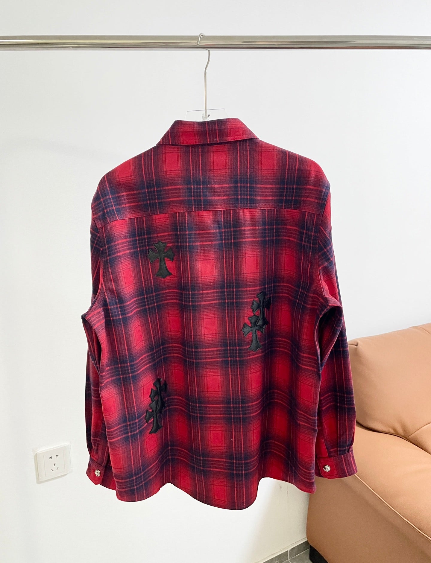 Long-sleeve red plaid shirt back view with dark embroidered motifs