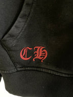 Dark hoodie with red embroidered monogram on lower chest