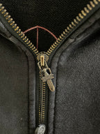 Dark hoodie zipper with gold-tone pull and black fabric placket