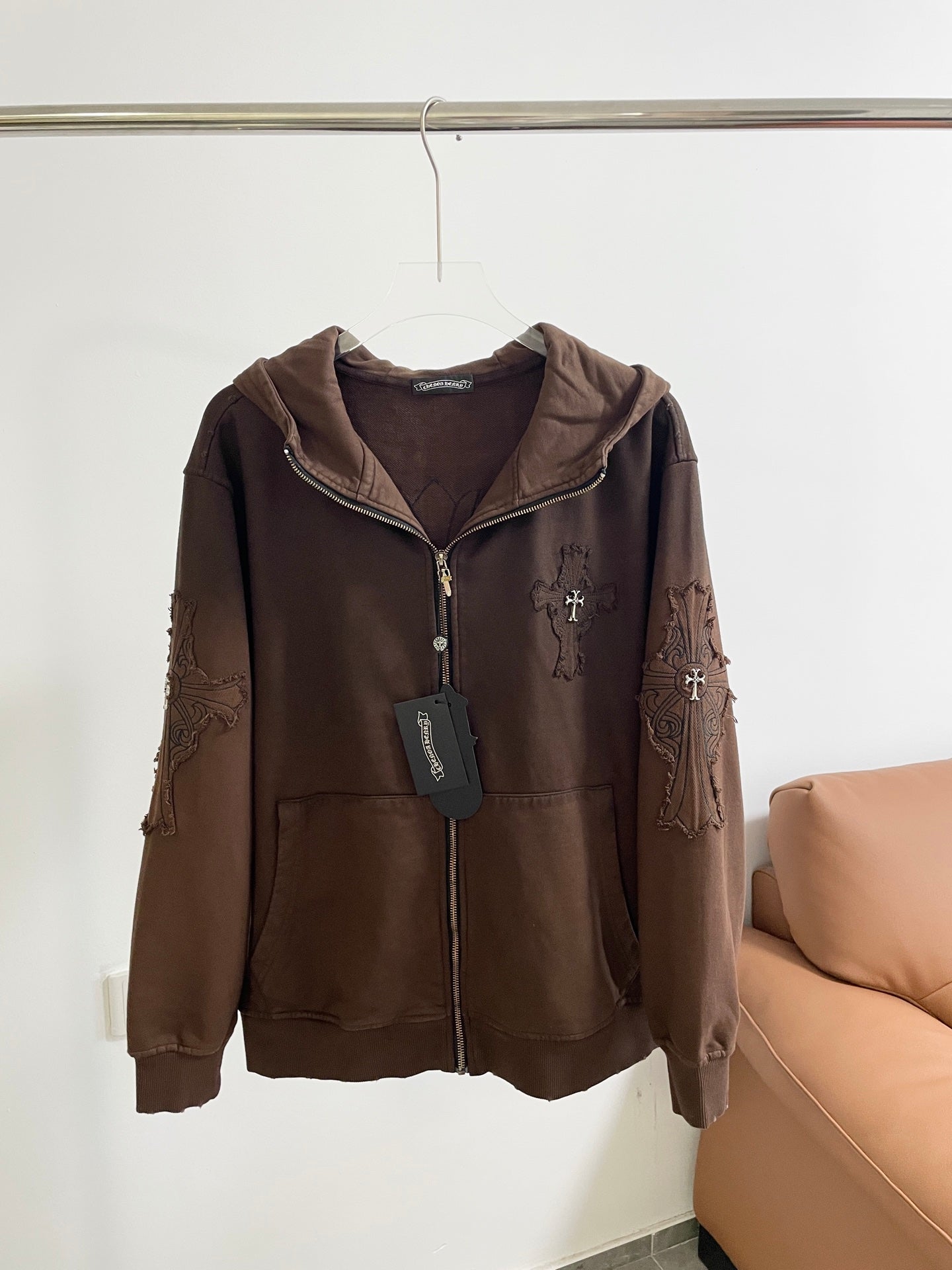 Long sleeve zip-up hooded jacket, brown, with front zipper and graphic accents