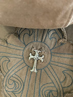 Embroidered round crest logo with ornate scrollwork on hood