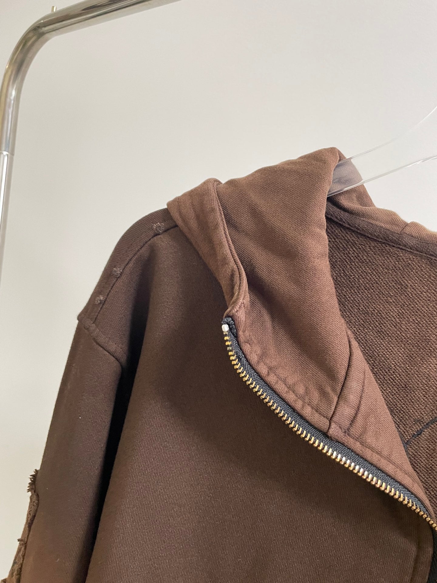 Brown hoodie shoulder and hood with gold zipper trim
