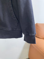 Dark hoodie sleeve and hem with ribbed cuff detail at the end of the arm