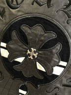 Embroidered flower emblem on dark circular crest patch with stitched border