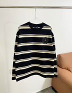 Navy long-sleeve shirt with cream horizontal stripes and black crest patch on chest