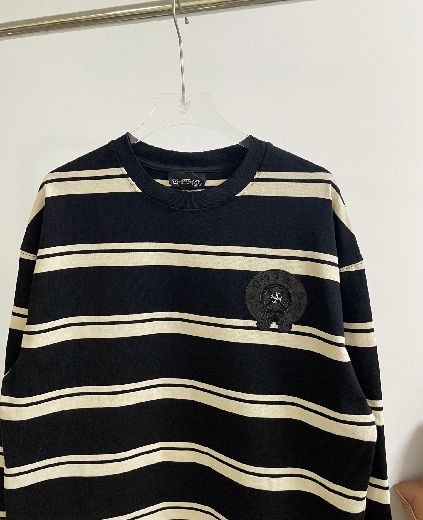 Navy striped long-sleeve shirt with ribbed crew neck and black crest patch