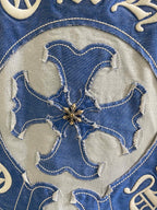 Close-up of blue embroidered flower-shaped elephant-style head on shirt logo