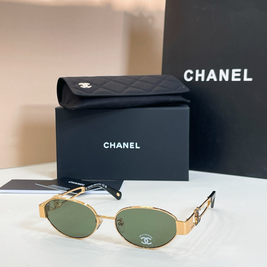 Chanel round sunglasses with gold frames and dark green lenses