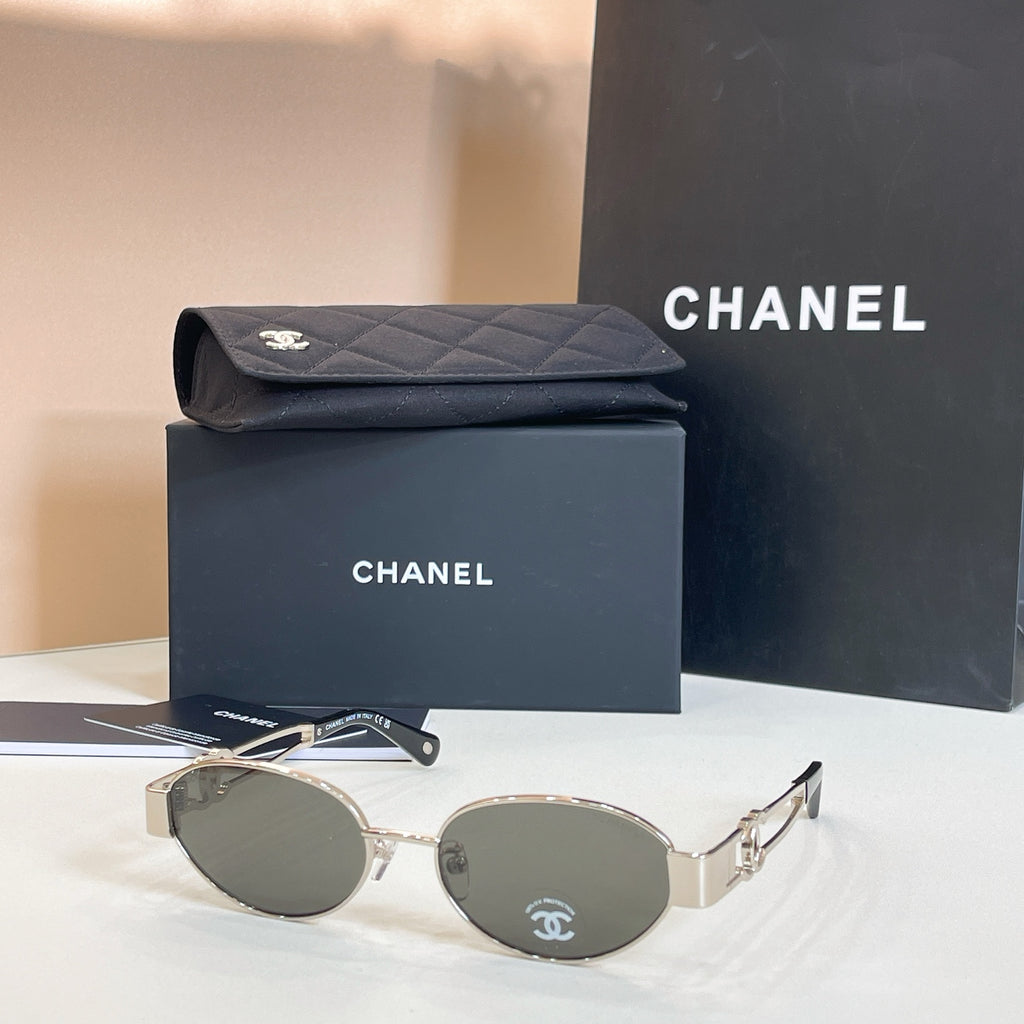 Chanel round sunglasses with gold-tone frames and dark gray lenses