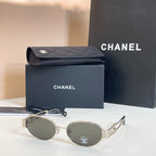 Chanel round sunglasses with gold-tone frames and dark gray lenses