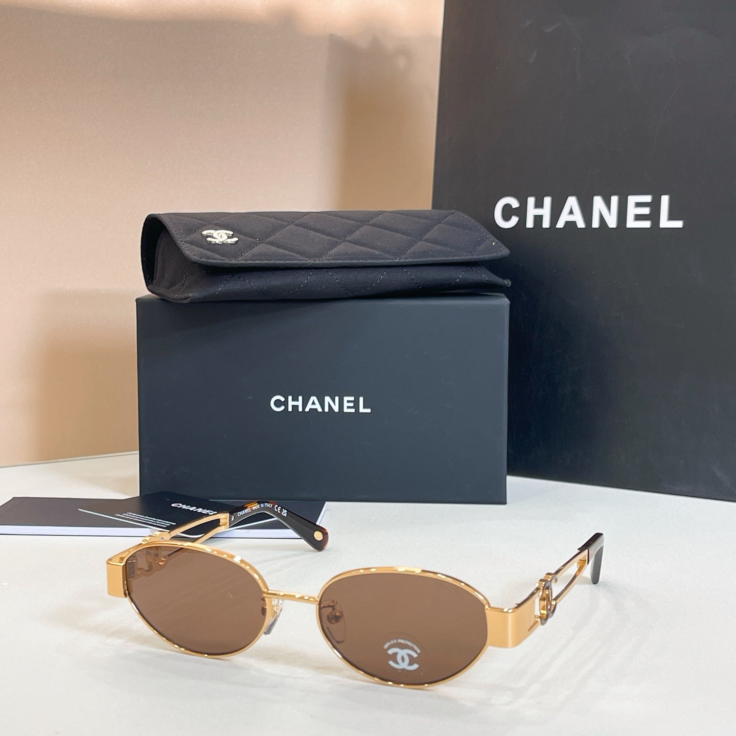 Chanel round sunglasses with gold frames and brown-tinted lenses