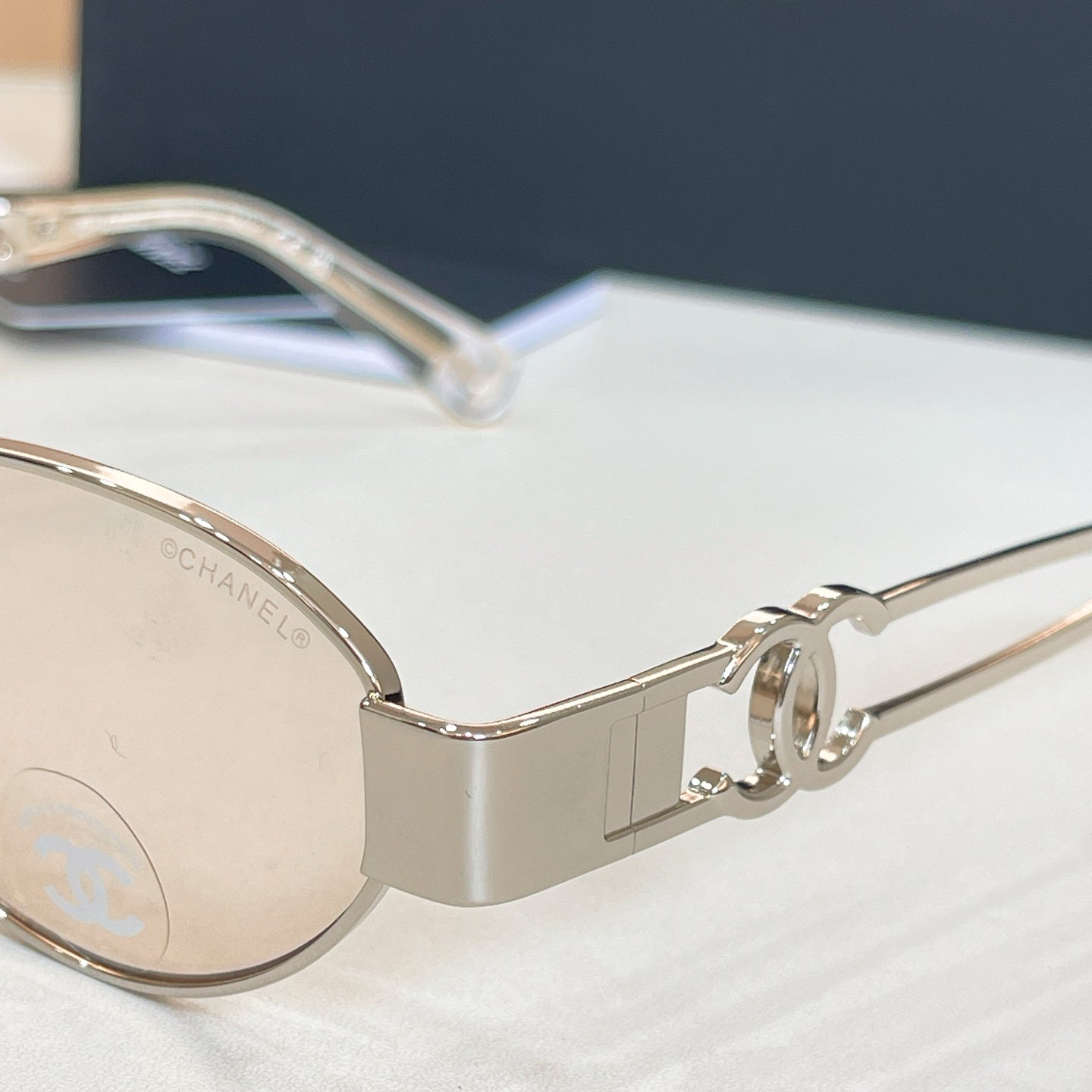 Chanel round sunglasses close-up of gold-tone frame and temple hinge