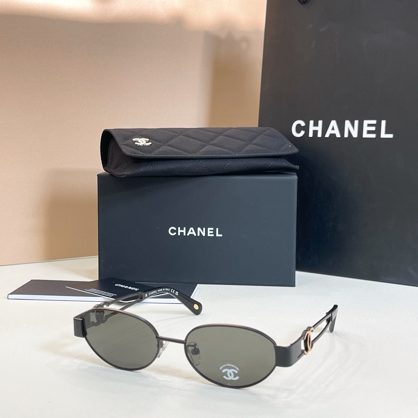 Chanel round sunglasses with gold-tone frames and dark gray lenses