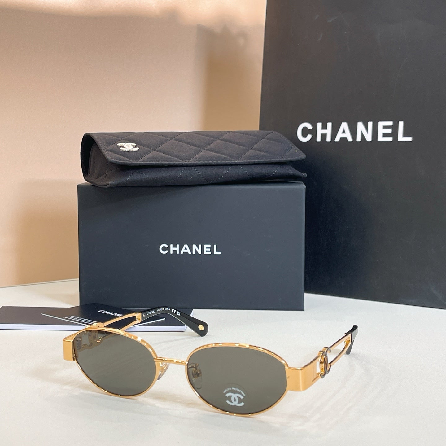 Chanel round sunglasses with gold-tone frames and dark green lenses
