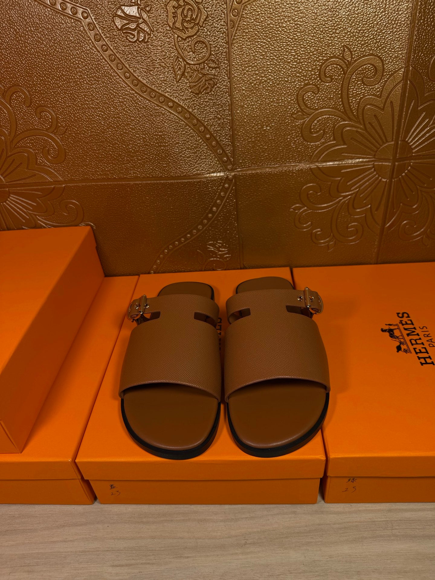 Brown leather slide sandals with two wide straps and silver buckle hardware