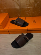 Dark brown leather slide sandals with metal buckle, two pairs on display