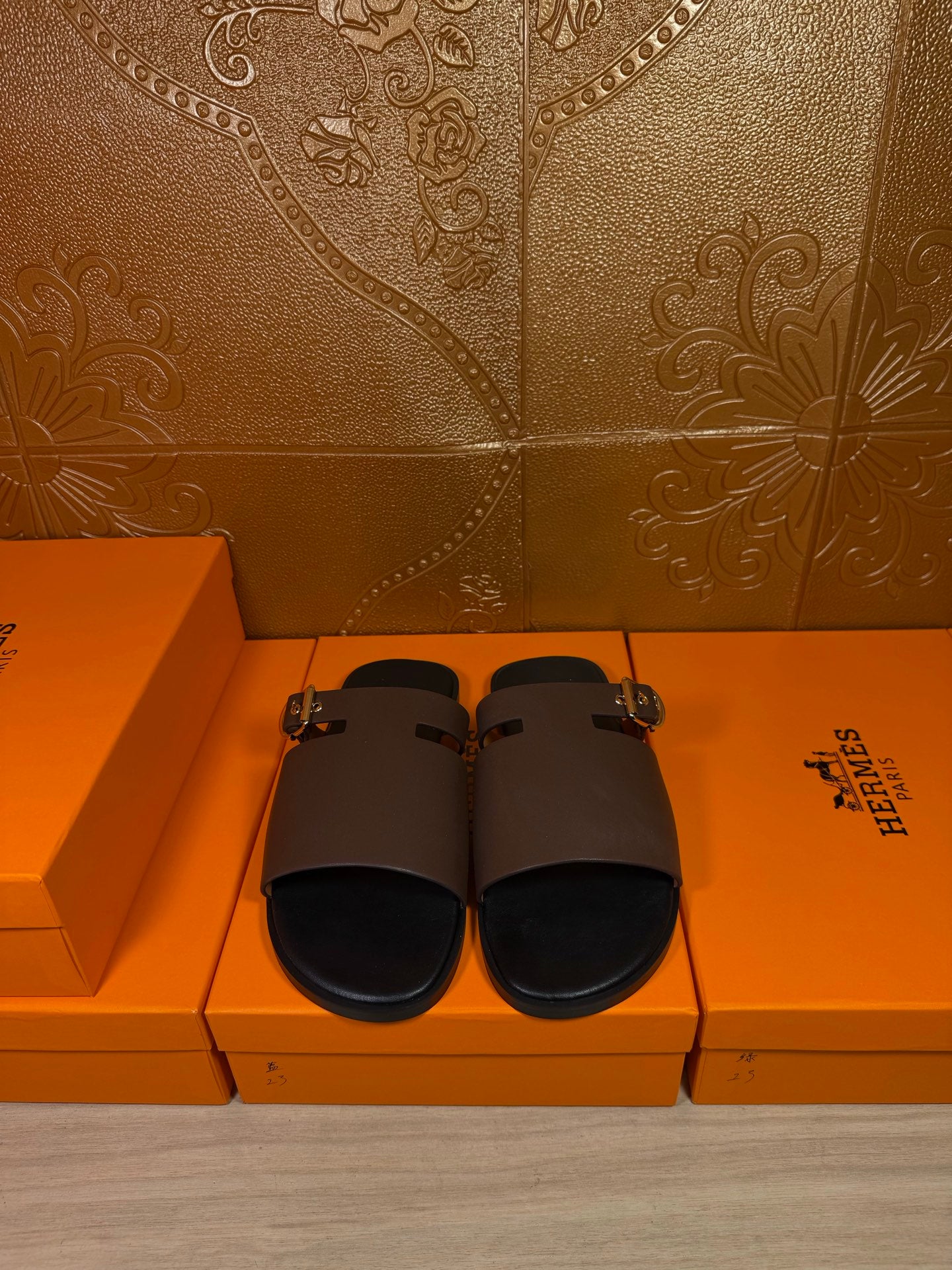 Dark brown leather slide sandals with wide straps and silver-tone buckle