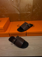 Dark brown leather slide sandals with silver buckle, side angle