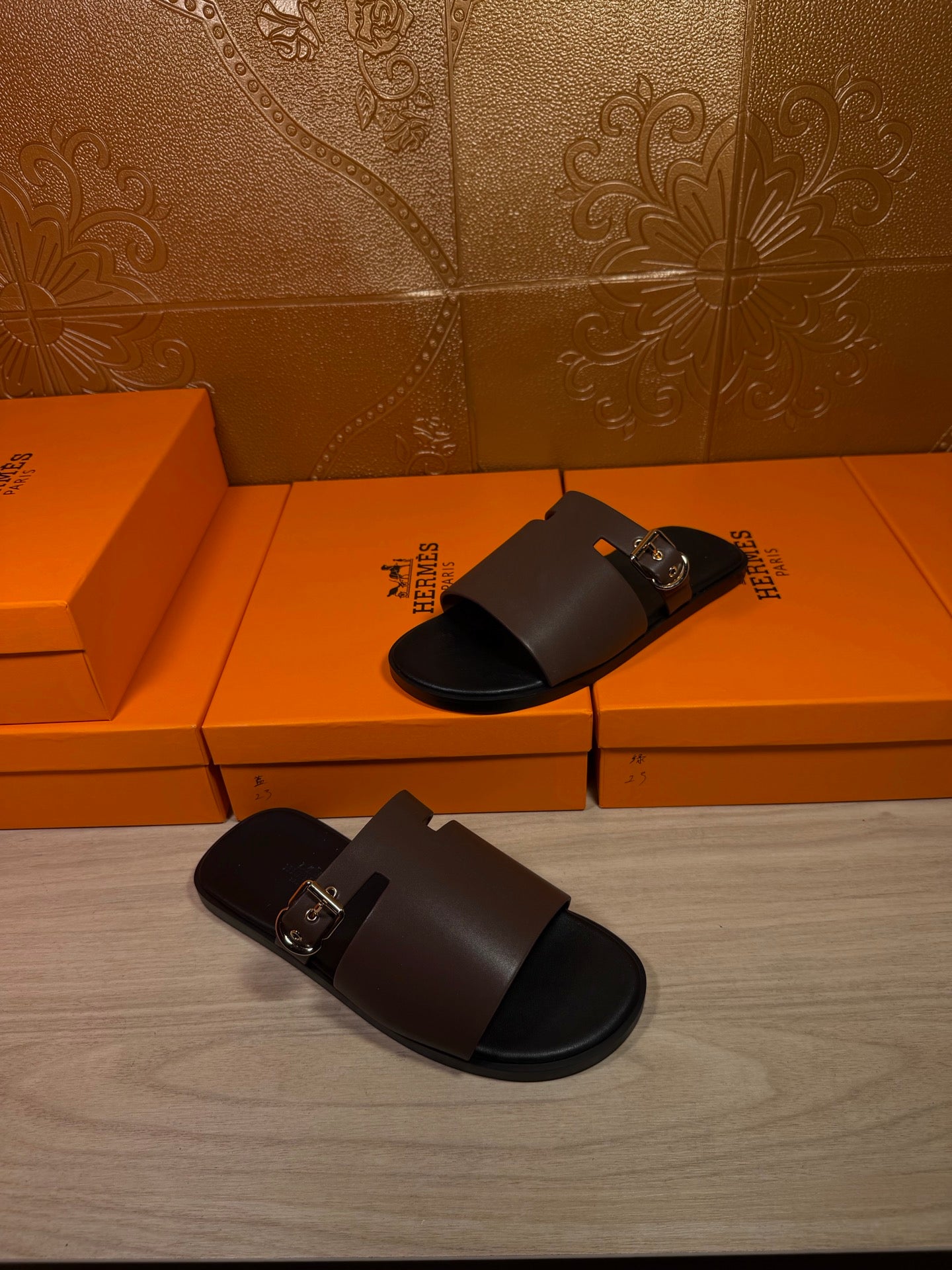 Dark brown leather slide sandals with silver buckle, side angle