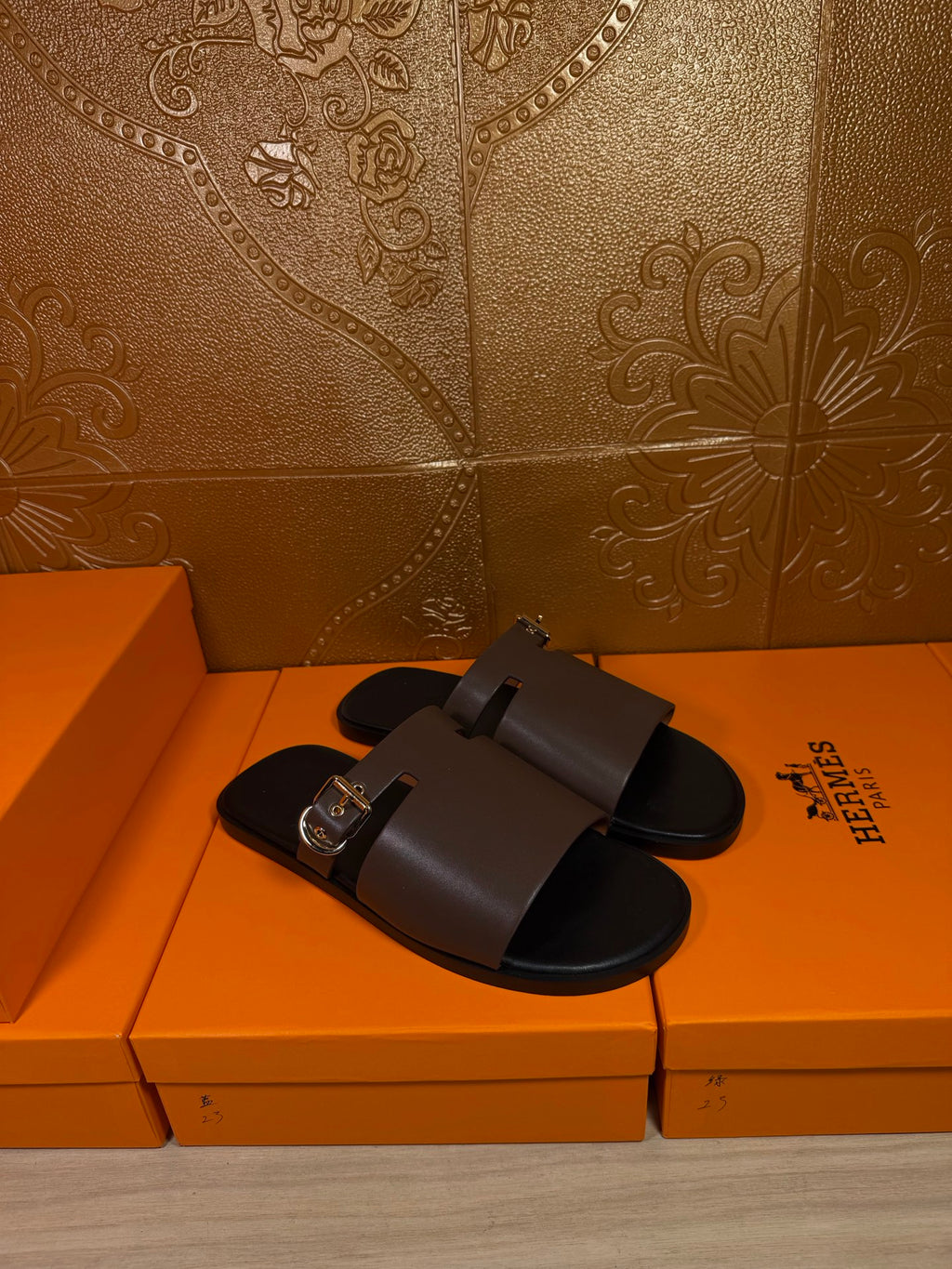 Pair of dark brown leather slide sandals with square silver buckles