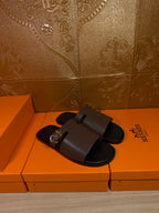 Pair of dark brown leather slide sandals with square silver buckles