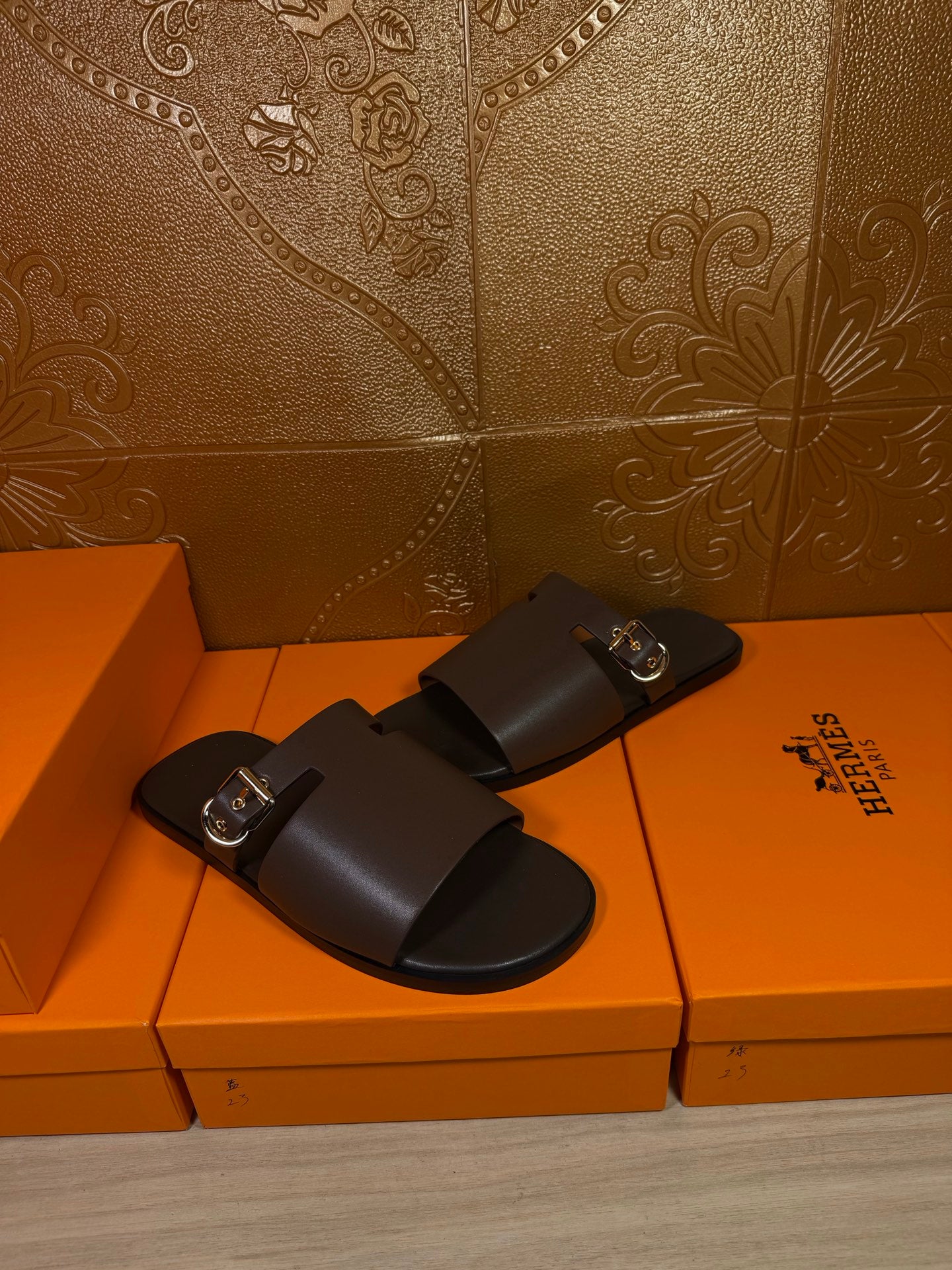 Hermes dark leather slide sandals with silver-tone buckle on strap
