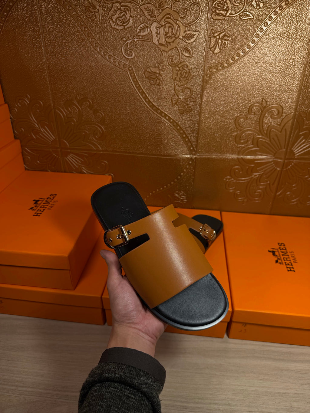 Leather slide sandals, tan strap with gold buckle and black footbed