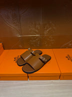Hermes leather slide sandals with double buckled straps, dark brown